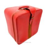 An Asprey, red leather travelling case with clean, cream-coloured silk interior