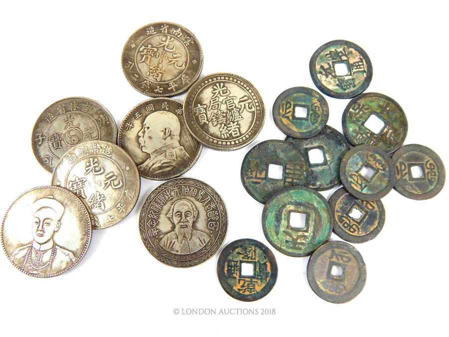 A collection of Chinese metal and white metal coins