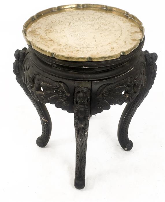 An oriental, ebonised, occasional table with an engraved brass tray top