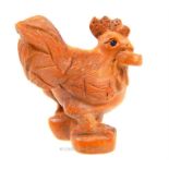 A carved wooden netsuke in the form of a cockerel