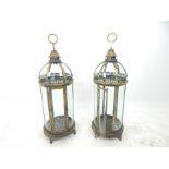 A pair of large storm lanterns with brass fittings; 79cm high.