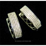 A pair of 14 ct white gold and diamond-studded hooped, stud earrings