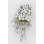 A sterling silver, floral spray brooch set with white crystals and opalites