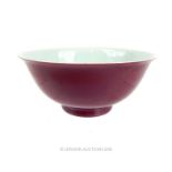 A Chinese, porcelain footed bowl with exterior, plum-coloured glaze