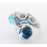 A sterling silver, blue enamel and blue cabochon stone ring