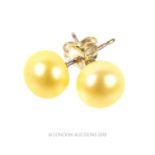 A pair of sterling silver and yellow/creamy- coloured, pearl studs