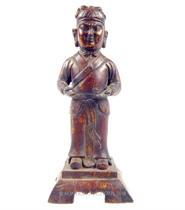 A Chinese, bronzed figure of a standing gentleman, traces of gilding