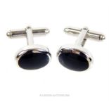 A pair of sterling silver and black, oval, onyx cufflinks