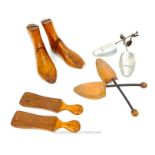 A collection of wooden shoe lasts and metal wooden shoe trees .