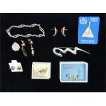 A collection of silver earrings, pendants and a large silver brooch