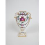 An early 20th century Dresden hard paste porcelain twin handled vase