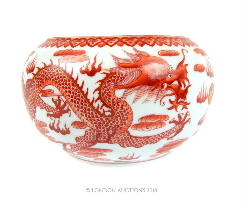 A Chinese ceramic bowl decorated with red dragons; 16cm diameter.