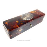 A tortoiseshell box set with an oval, sterling silver cartouche