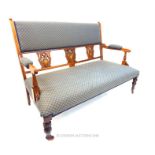 An Edwardian Art Nouveau walnut and inlaid two seater sofa