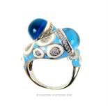 A sterling silver, blue enamel and blue cabochon stone ring