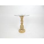 A glass topped side table with gilt pineapple support.