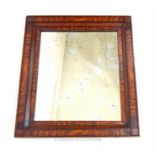 A 19th century mirror, with an inlaid wood frame