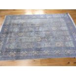 A fine silk qum rug in shades of blue and silver