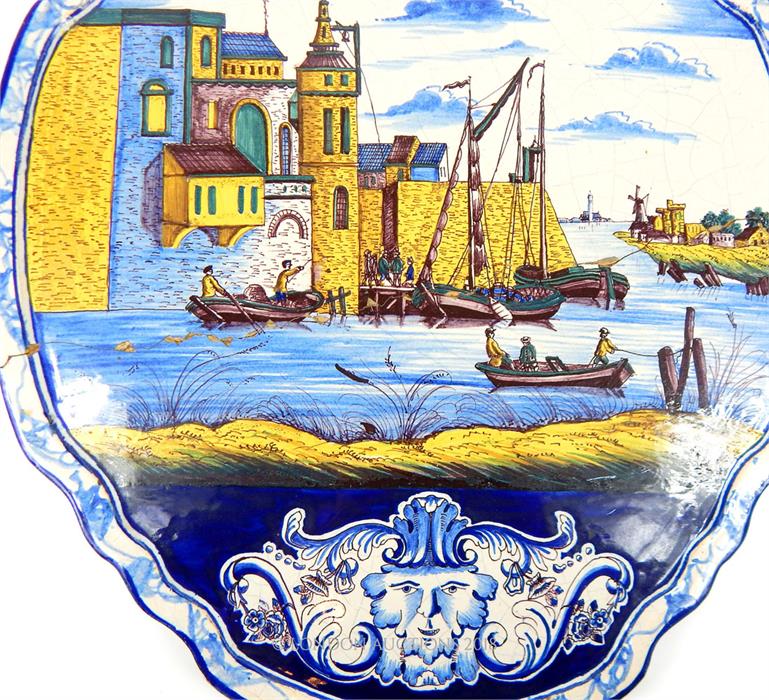 A 19th century Dutch polychrome, Delft pottery, plaque depicting a harbour scene; 57.5cm long. - Image 2 of 2