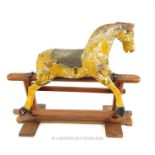 A 19th century small ,carved wooden, rocking horse with a distressed finish; without tail; 73cm