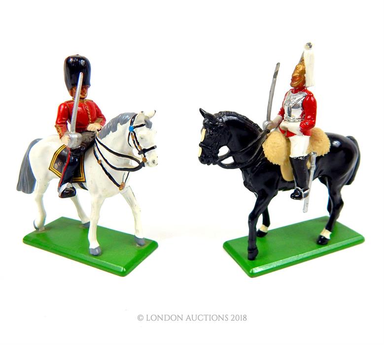 Two die-cast metal Britains model mounted British army cavalry on parade; both without boxes.