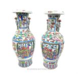 A pair of oriental, famille rose pattern vases, phoenix style lug handles; 64 cm high.