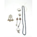 A collection of Bedouin jewellery: white rings and earrings inset with coloured stones together with