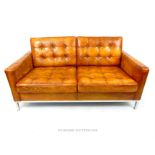 A contemporary tan leather sofa
