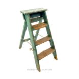 A set of petite, vintage, rustic, green-painted step ladders