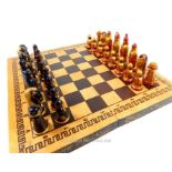 A complete, Russian chess set with board and hand-painted and gilded pieces