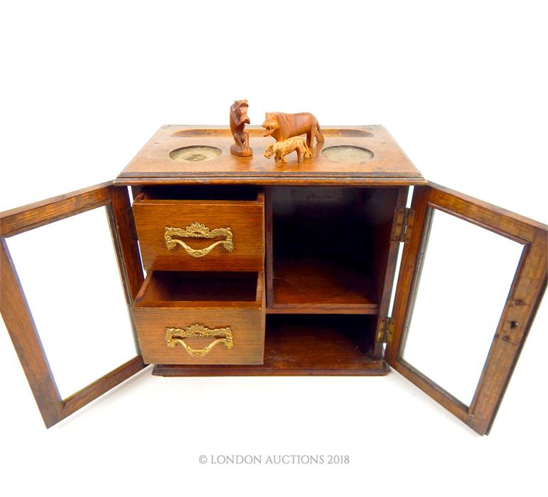 A wooden framed jewellery case with glazed doors and two internal drawers; 25.5 cm high.