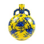 A Chinese, moon-flask with a yellow ground and hand-painted blue fruit