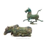 A bronzed metal figurine of the Flying Horse of Gansu (16.5cm high) a seated bronzed metal sacred