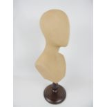 A mannequin bust raised upon wooden support; 62cm high.