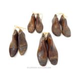 Four pairs of vintage wooden shoe lasts.