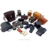 A collection of vintage cameras and binoculars