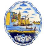 A 19th century Dutch polychrome, Delft pottery, plaque depicting a harbour scene; 57.5cm long.