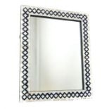 A rectangular wall mirror with geometric mother of pearl parquetry inlay