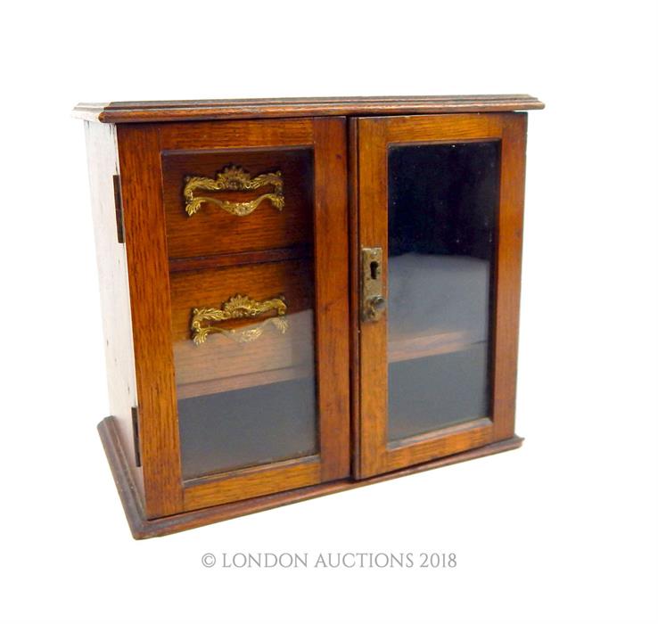 A wooden framed jewellery case with glazed doors and two internal drawers; 25.5 cm high. - Image 2 of 2