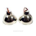 A pair of contemporary chromed industrial style domed hanging lights