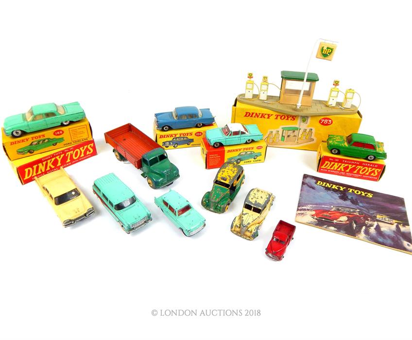 11 Dinky Toys model cars, a Petrol Pump station and a Dinky Toys catalogue: Mercedes Benz 220 SE