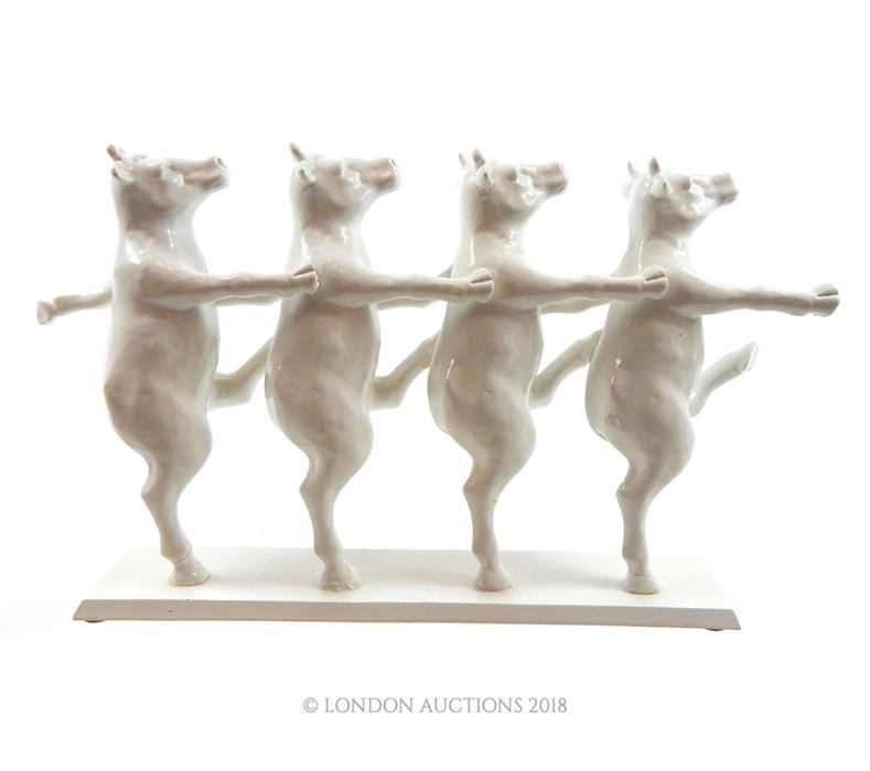 A 20th century composite figural group of marching cows; 33.5cm long. - Image 2 of 2