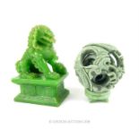 A carved, green jade concentric ball sculpture with a decorative dog of Fo