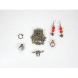 A small collection of Bedouin jewellery: white rings and earrings inset with coloured stones