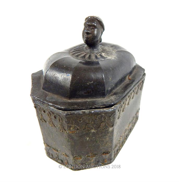 An Antique small lead casket, possibly middle-eastern with Nubian style bust to it lid; 12cm long.