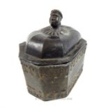 An Antique small lead casket, possibly middle-eastern with Nubian style bust to it lid; 12cm long.