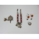 A collection of Bedouin jewellery: white rings and earrings inset with coloured stones together with