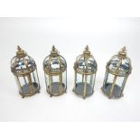 Four storm lanterns with distressed gilt frames; 47cm high.