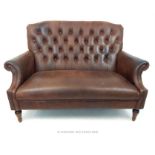 A contemporary Laura Ashley brown leather two seater sofa