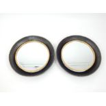 A pair of circular mirrors with receded industrial metal frames; 59cm diameter.